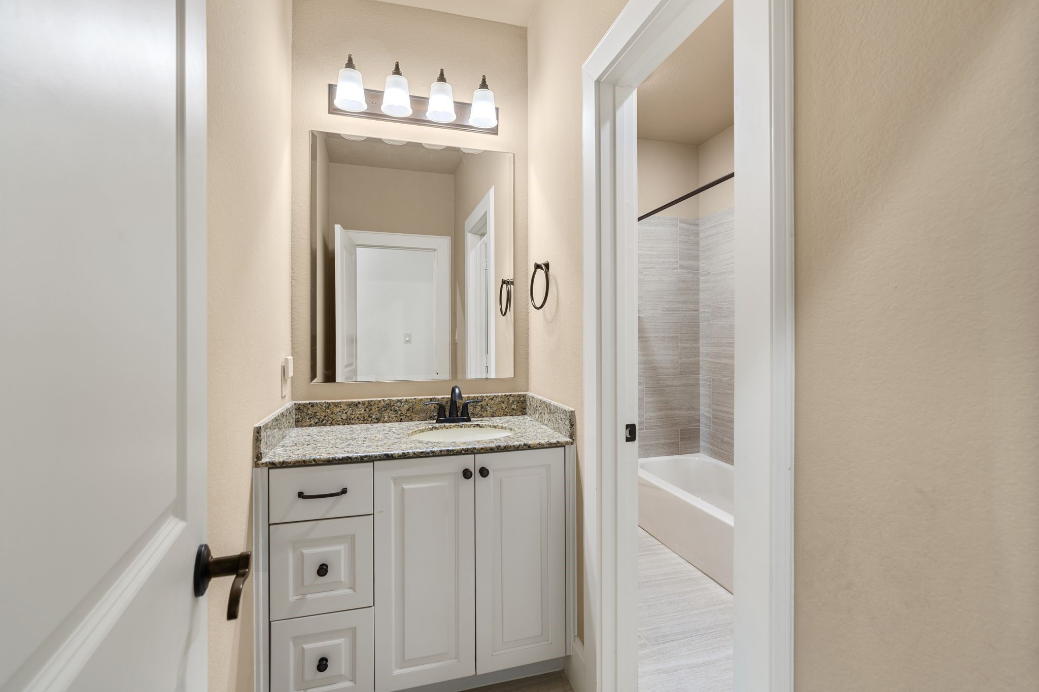 1418 Du Barry Lane Houston, TX 77018 - Photo 33 of 45 a bathroom with a granite countertop sink and a mirror