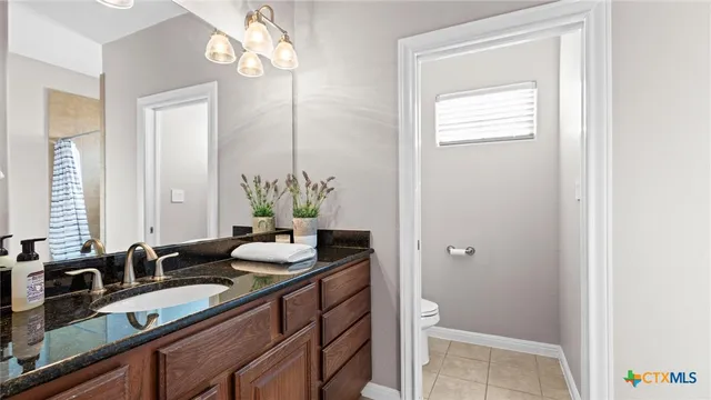 a bathroom with double vanity and a mirror