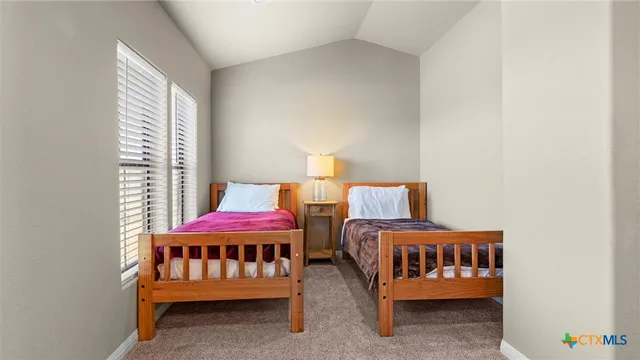 a bedroom with furniture and a window