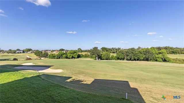 a roof deck with table and chairs