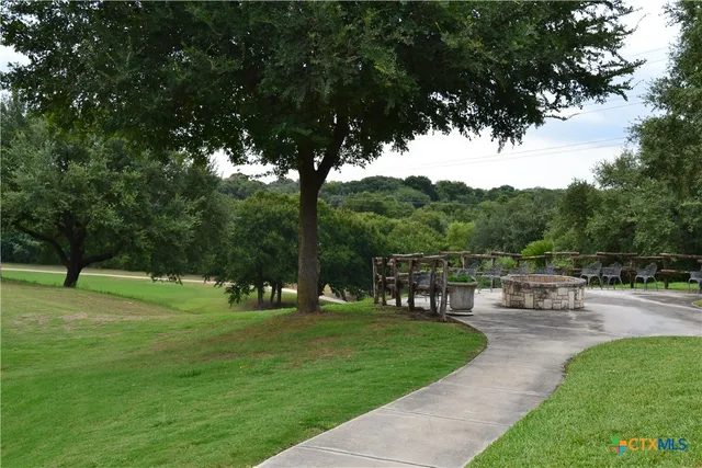 an aerial view of a city with lots of residential buildings ocean and mountain view in back