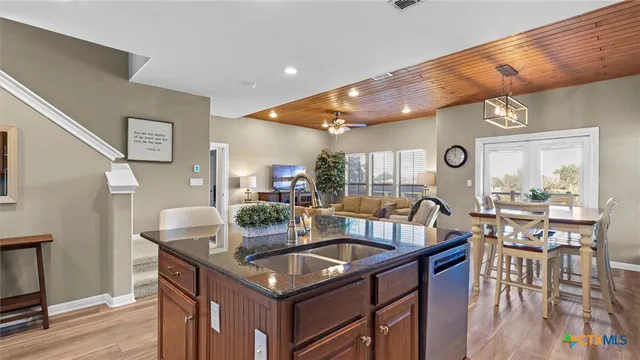 a kitchen with a table chairs and wooden floor