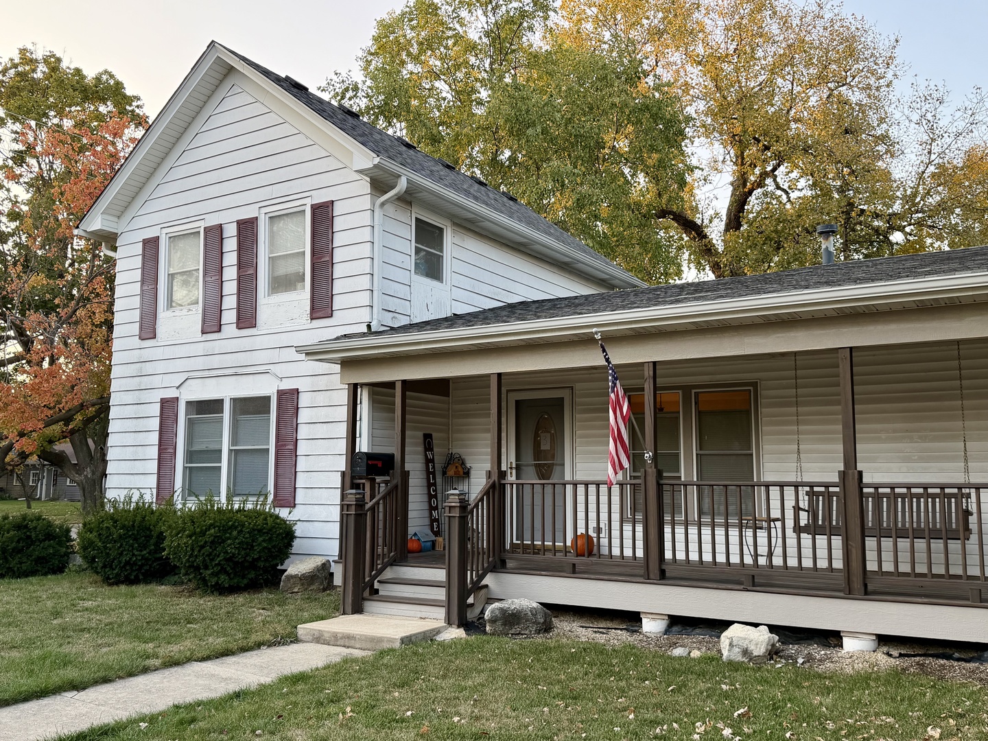 a view of a house with wooden deck and a yard