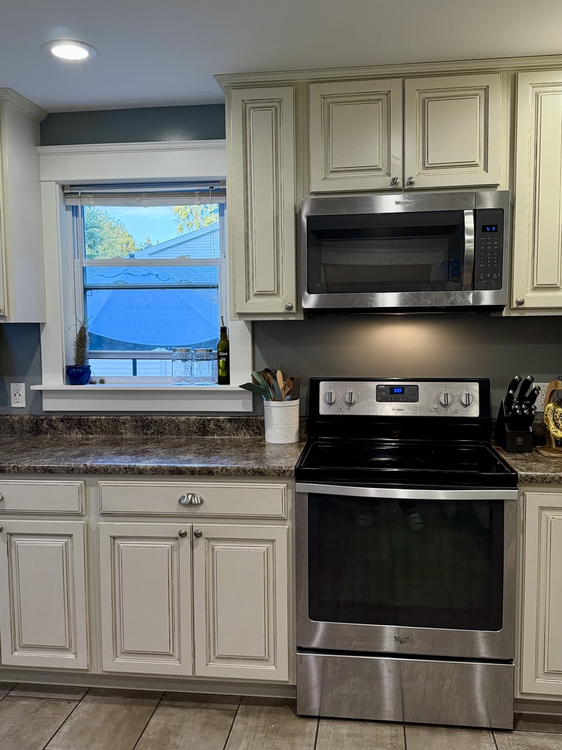 3 East Lee Street Plano, IL 60545 - Photo 2 of 2 a kitchen with granite countertop a stove microwave and sink