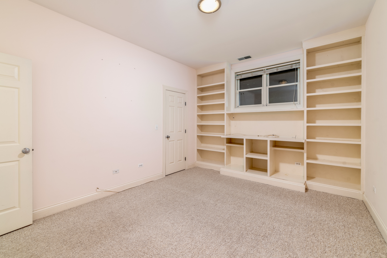 4425 North Racine Avenue, Unit 1S Chicago, IL 60640 - Photo 21 of 28 a view of an empty room with a empty shelves