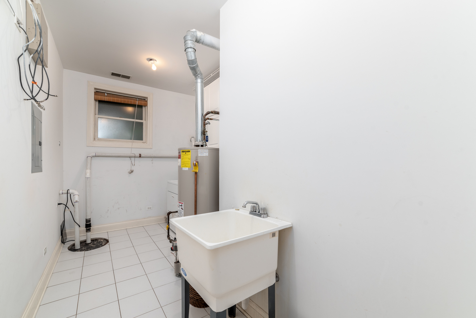 4425 North Racine Avenue, Unit 1S Chicago, IL 60640 - Photo 23 of 28 a bathroom with a sink and a mirror