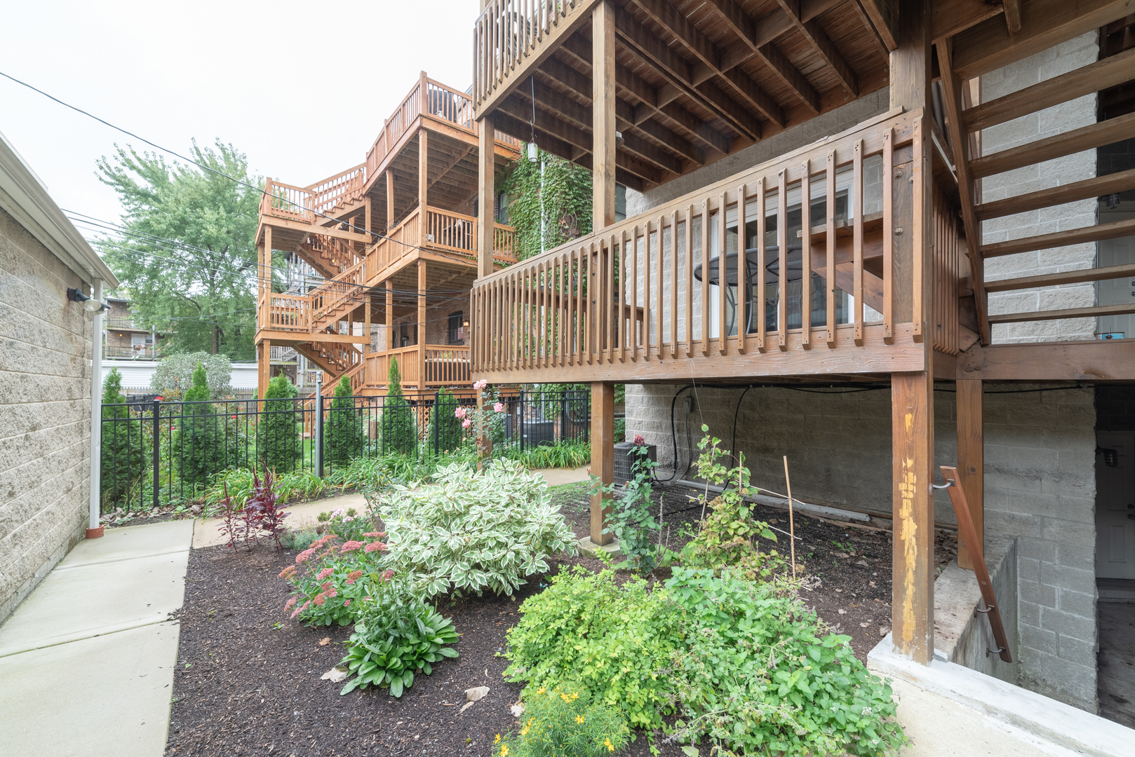 4425 North Racine Avenue, Unit 1S Chicago, IL 60640 - Photo 26 of 28 a house with potted plants in front of it