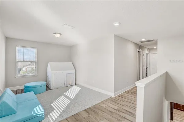 a bedroom with furniture and a wooden floor
