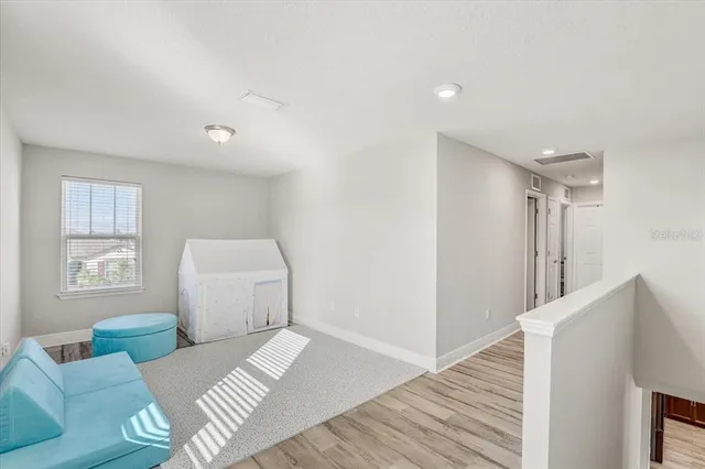 a bedroom with furniture and a wooden floor