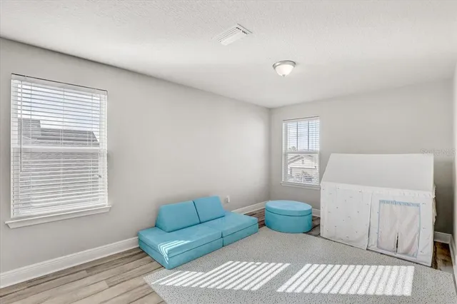 a bedroom with furniture and a window