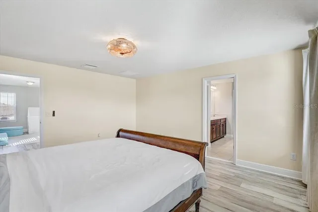 a bedroom with a bed and a table