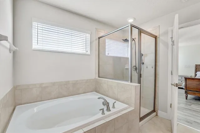 a bathroom with a bathtub and a shower