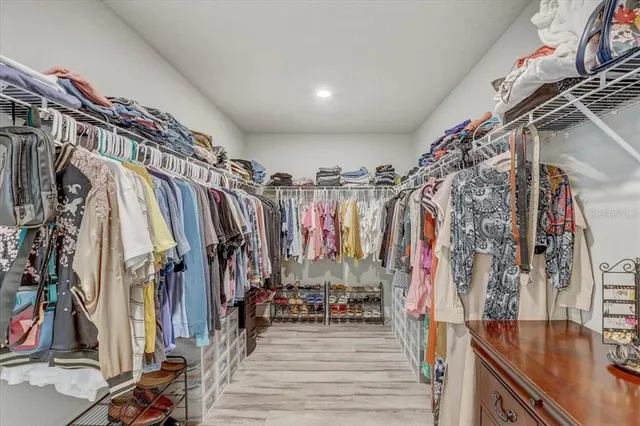 a view of walk in closet with clothes