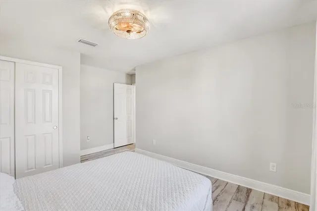 a view of a hallway with a chandelier fan