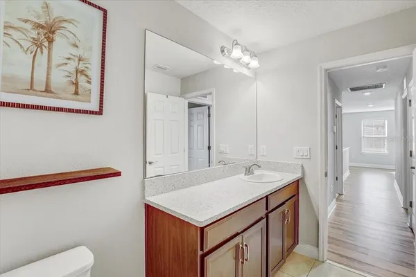 a bathroom with a sink a toilet and a mirror