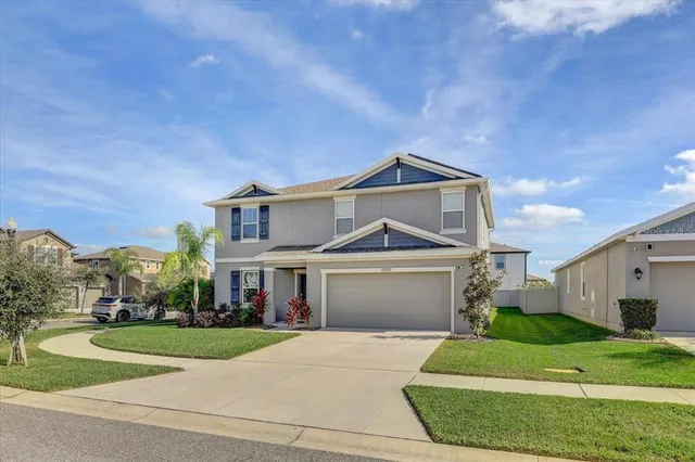 a front view of a house with a yard and garage