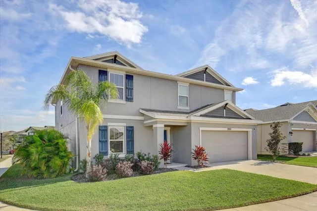 a front view of a house with a garden and plants