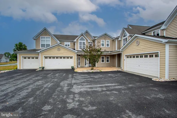 a view of a house with a yard and garage