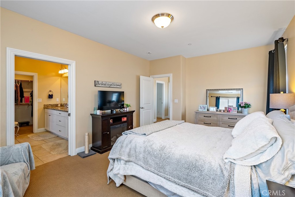 419 Junipero Way San Luis Obispo, CA 93401 - Photo 14 of 29 a bedroom with a bed and a flat screen tv