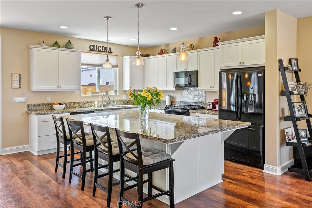419 Junipero Way San Luis Obispo, CA 93401 - Photo 6 of 29 a kitchen with granite countertop a table chairs microwave and cabinets