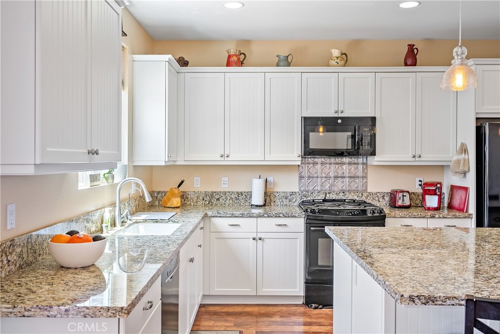 419 Junipero Way San Luis Obispo, CA 93401 - Photo 8 of 29 a kitchen with stainless steel appliances granite countertop a sink stove and cabinets