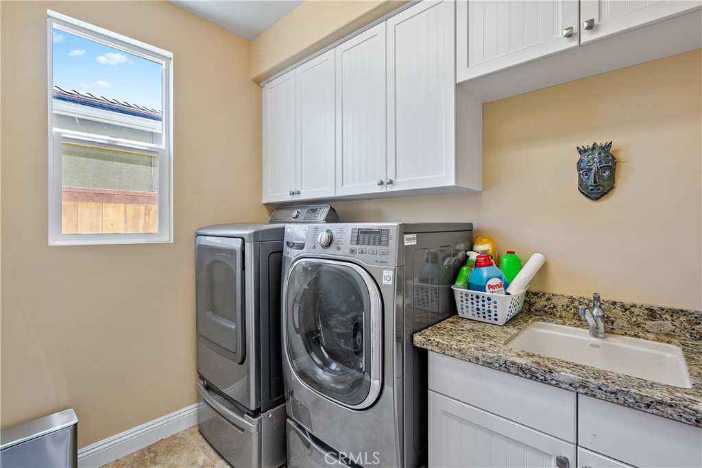 419 Junipero Way San Luis Obispo, CA 93401 - Photo 10 of 29 a utility room with granite countertop cabinets washer and dryer
