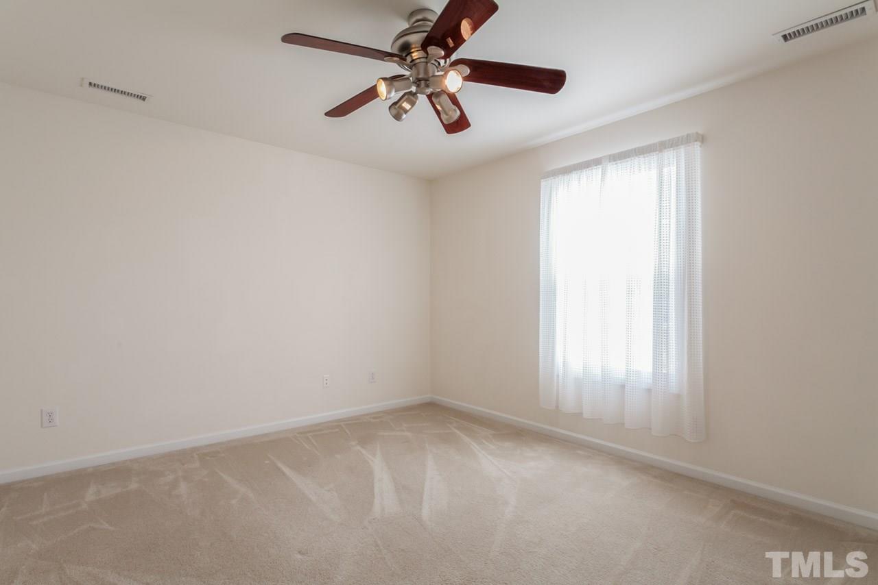 4004 Iverson Street Raleigh, NC 27604 - Photo 17 of 24 an empty room with a window and a fan