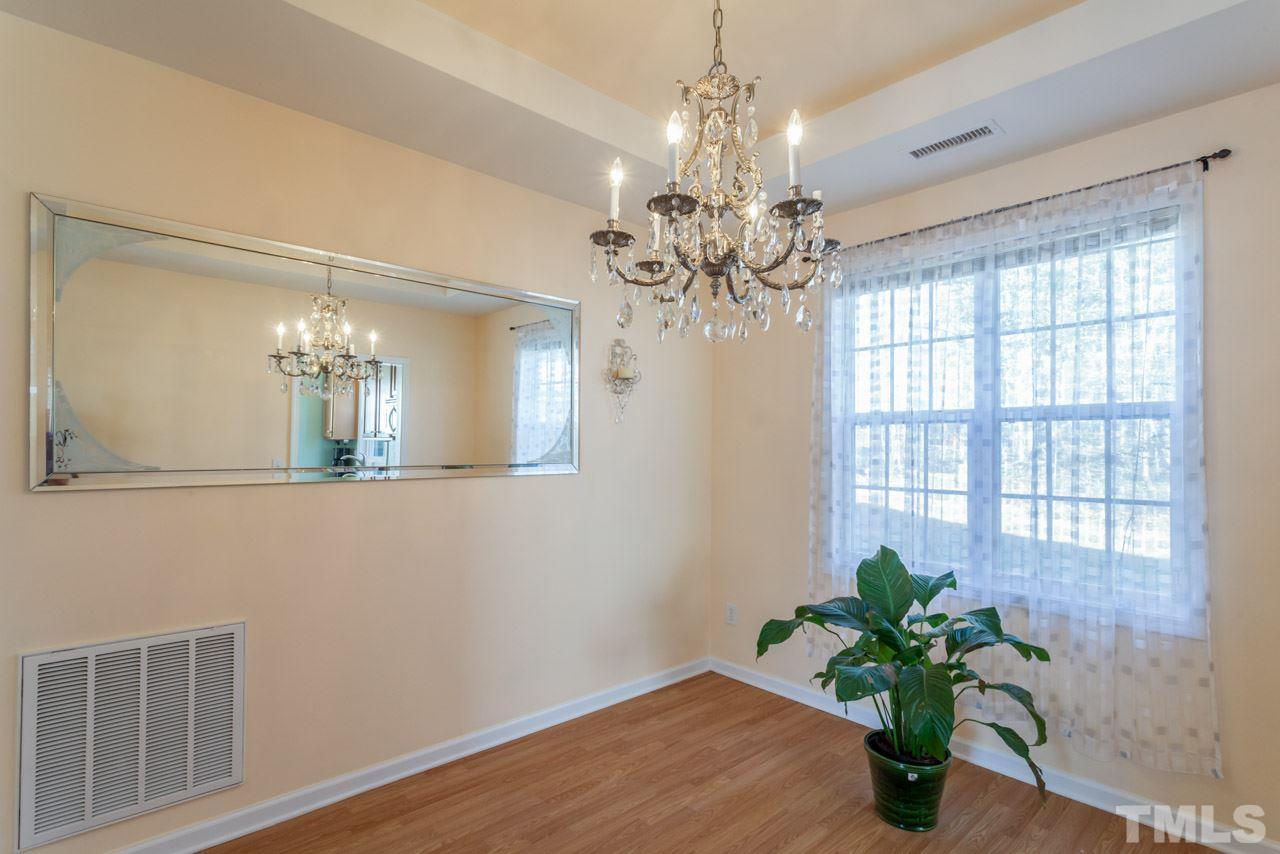 4004 Iverson Street Raleigh, NC 27604 - Photo 7 of 24 a view of a room with a chandelier and wooden floor