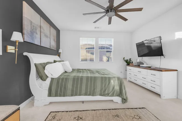 a spacious bathroom with a granite countertop sink a toilet mirror and bathtub