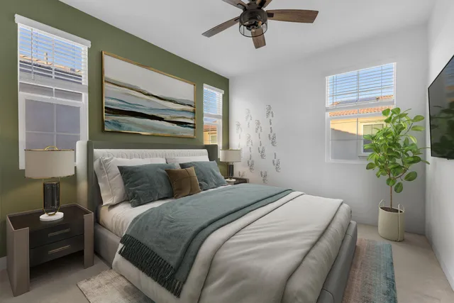 an empty room with windows and chandelier fan
