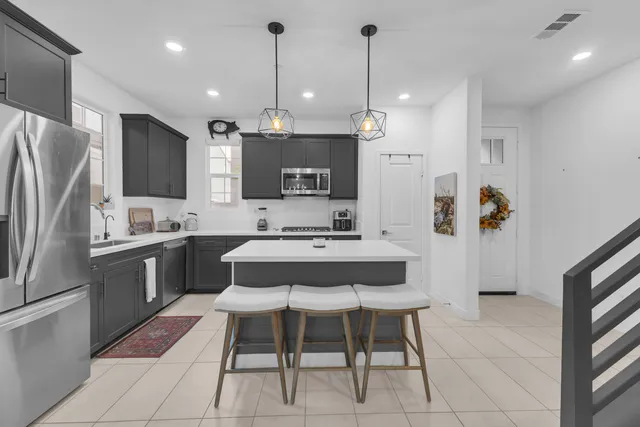 a living room with furniture flowerpot and a chandelier