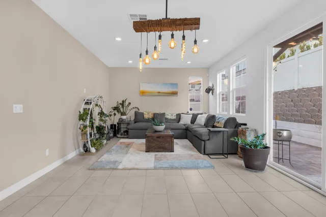 a living room with furniture and a chandelier