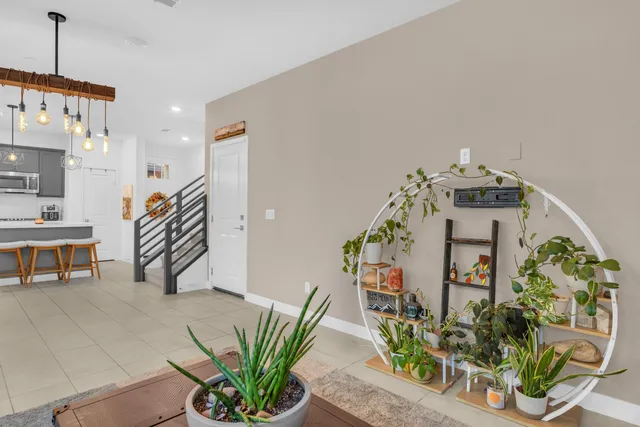 a living room with furniture potted plant and windows