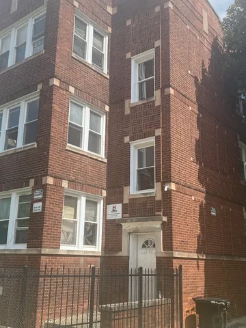a view of a brick building next to a yard