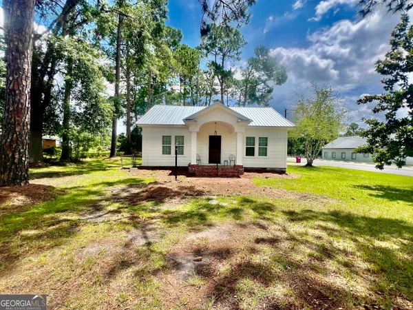 a front view of a house with a yard