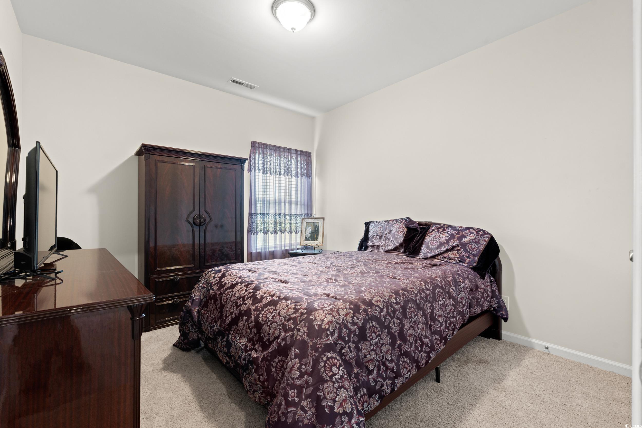 327 Fox Bay Road Loris, SC 29569 - Photo 12 of 23 Bedroom featuring light carpet and baseboards.