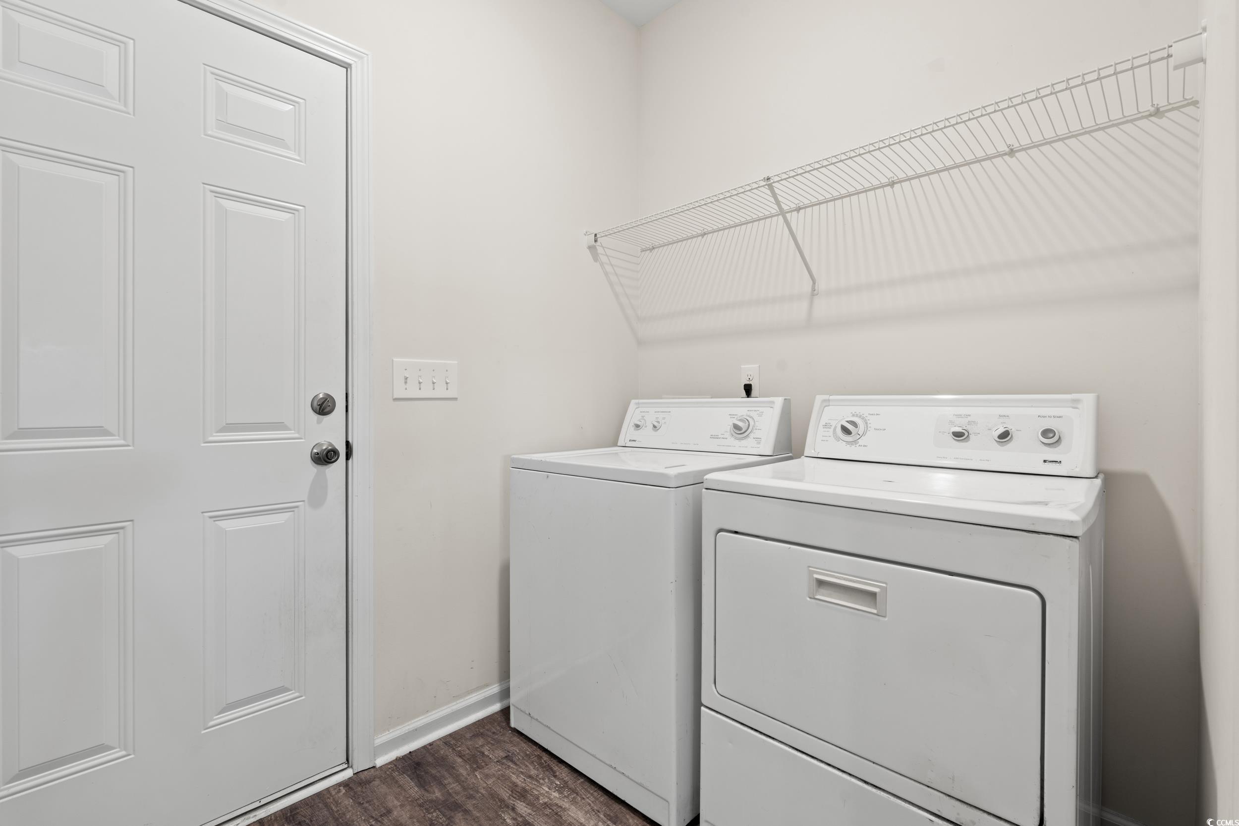 327 Fox Bay Road Loris, SC 29569 - Photo 16 of 23 Laundry room featuring dark wood-style floors and washer and clothes dryer. Laundry located off garage.