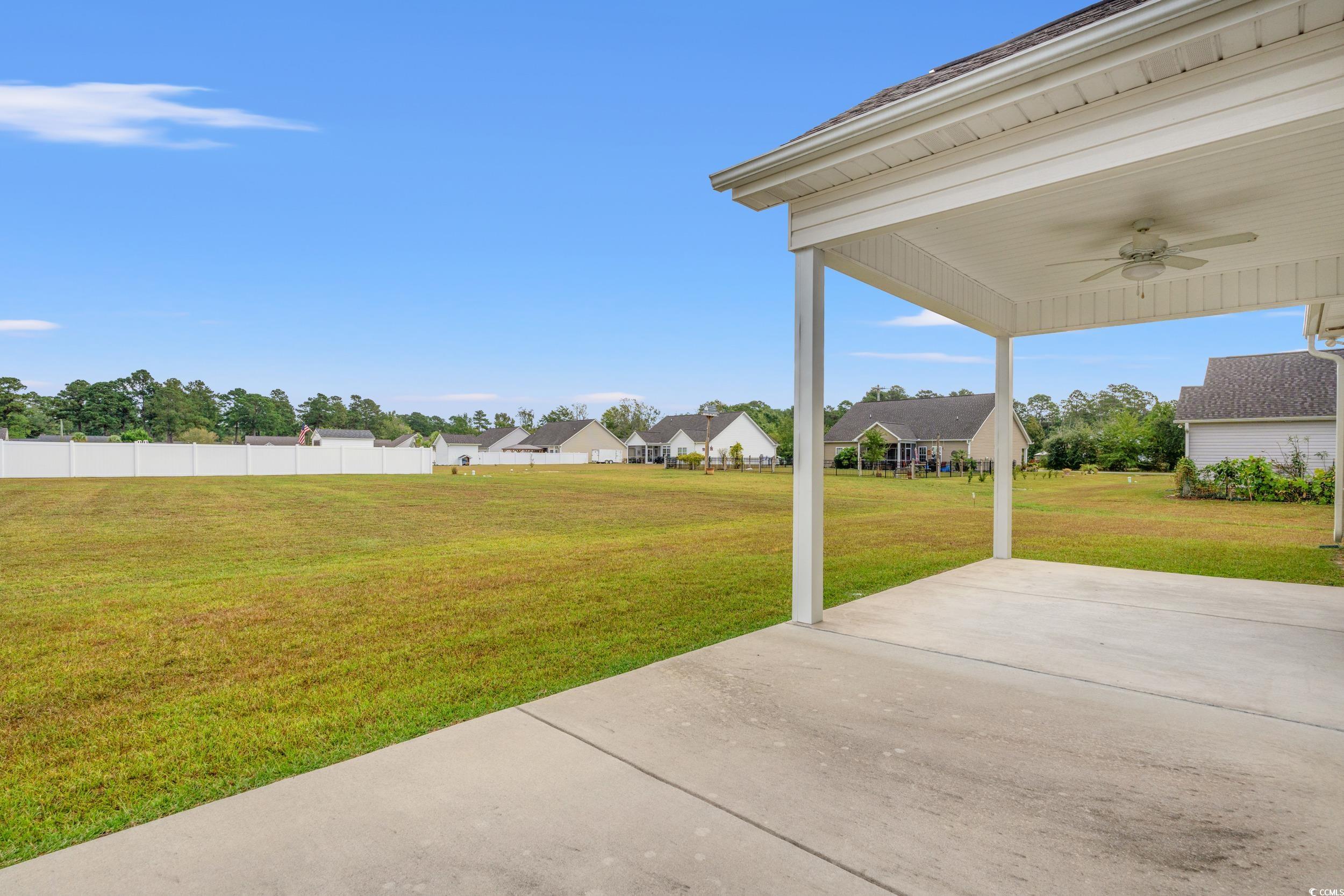 327 Fox Bay Road Loris, SC 29569 - Photo 18 of 23 Rear. View of patio featuring ceiling fan and a residential view.