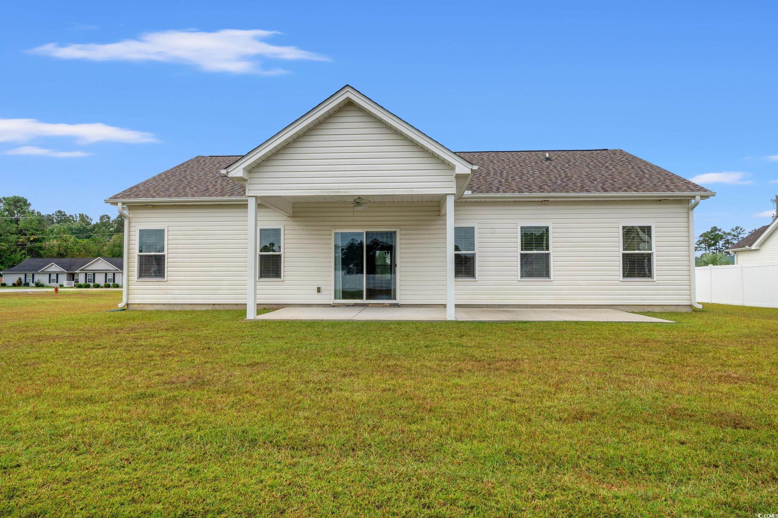 327 Fox Bay Road Loris, SC 29569 - Photo 19 of 23 Back of house featuring a patio and yard.