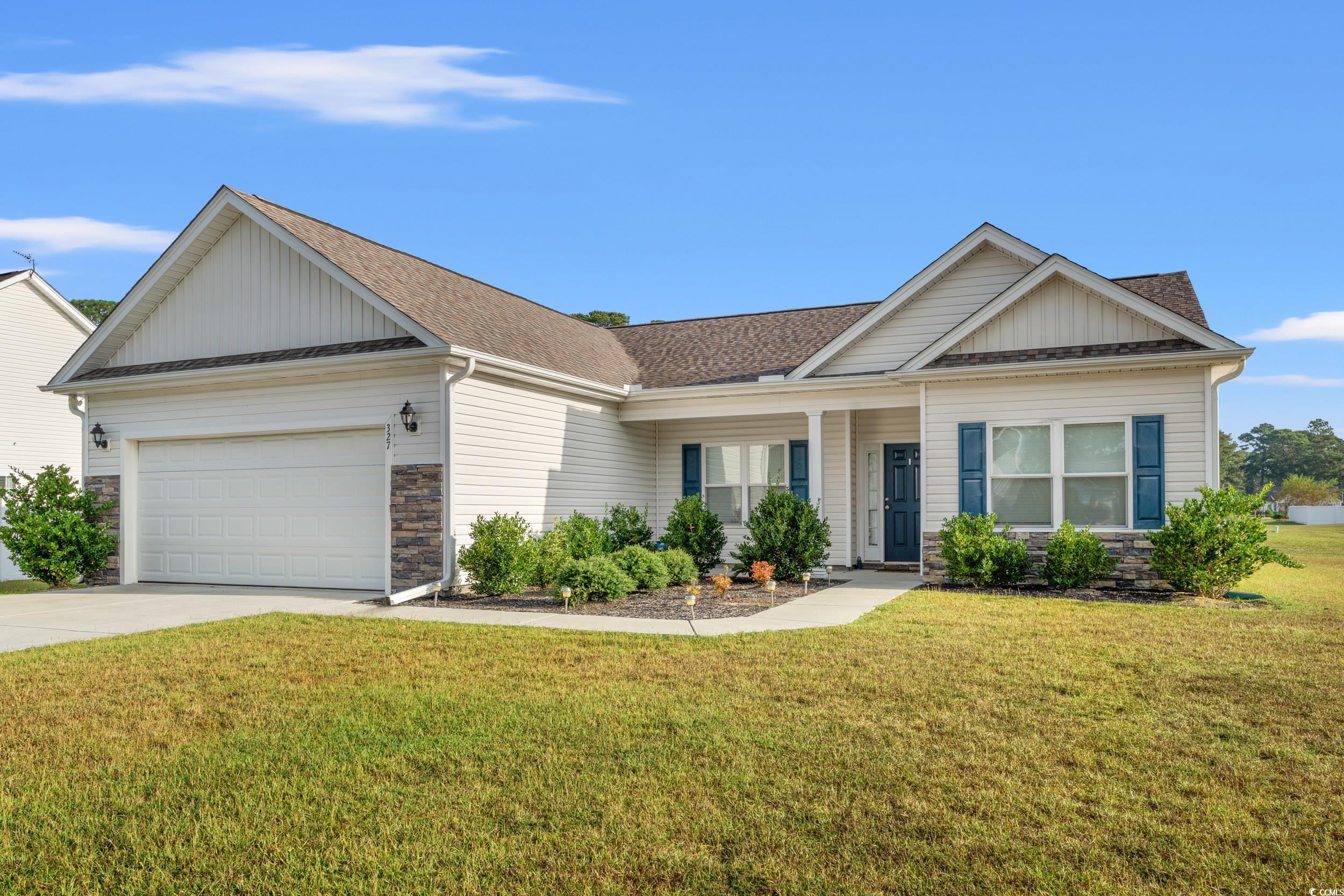 327 Fox Bay Road Loris, SC 29569 - Photo 2 of 23 Single story home featuring stone siding, board and batten siding, covered porch, and a front yard