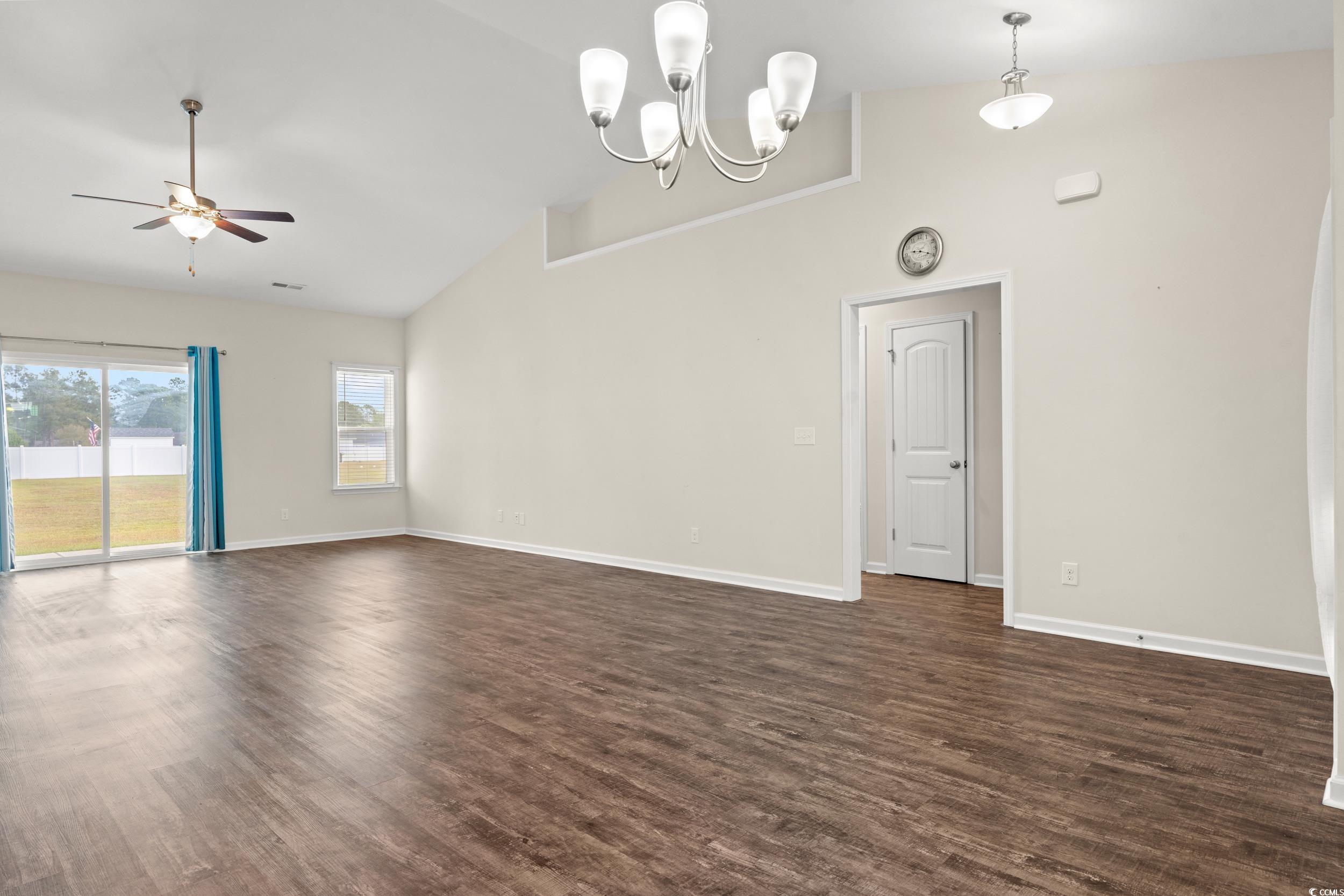 327 Fox Bay Road Loris, SC 29569 - Photo 6 of 23 Unfurnished living room featuring dark wood-style floors, high vaulted ceiling, a chandelier, and a ceiling fan
