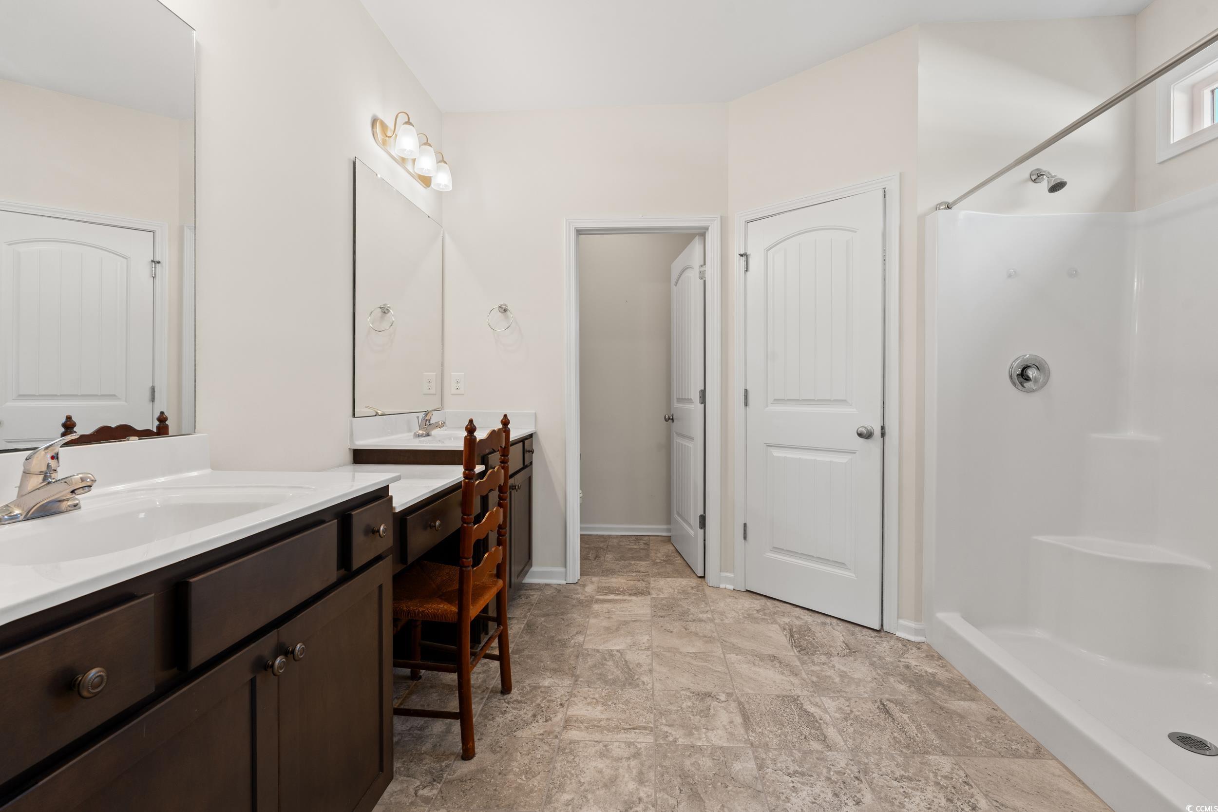327 Fox Bay Road Loris, SC 29569 - Photo 10 of 23 Full bath with a walk-in shower, two vanities, and tile floors.