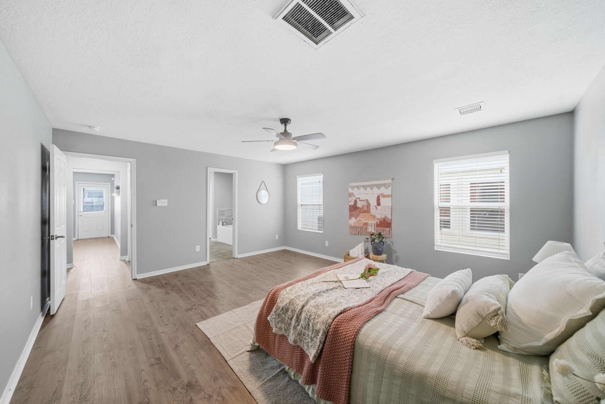 14422 Leafy Tree Drive Houston, TX 77090 - Photo 18 of 40 a bedroom with a large bed and a chandelier