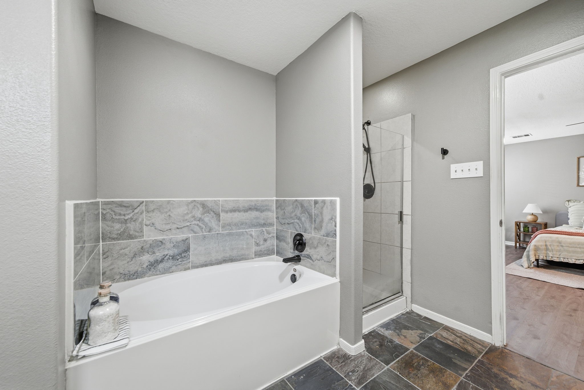 14422 Leafy Tree Drive Houston, TX 77090 - Photo 21 of 40 a bathroom with a bathtub and a shower