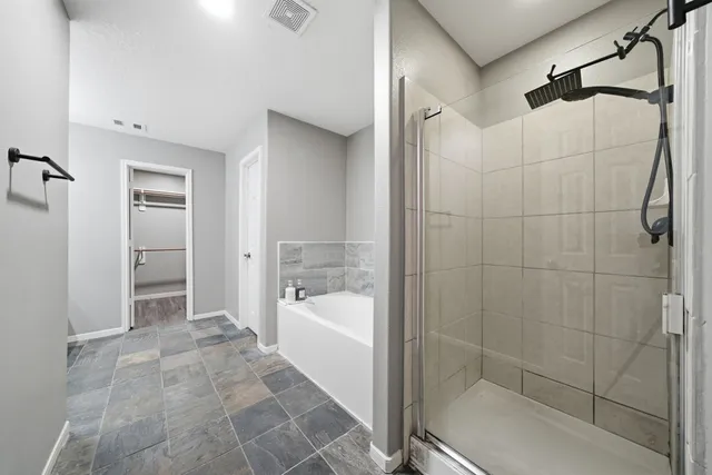 a bathroom with a bathtub and a shower