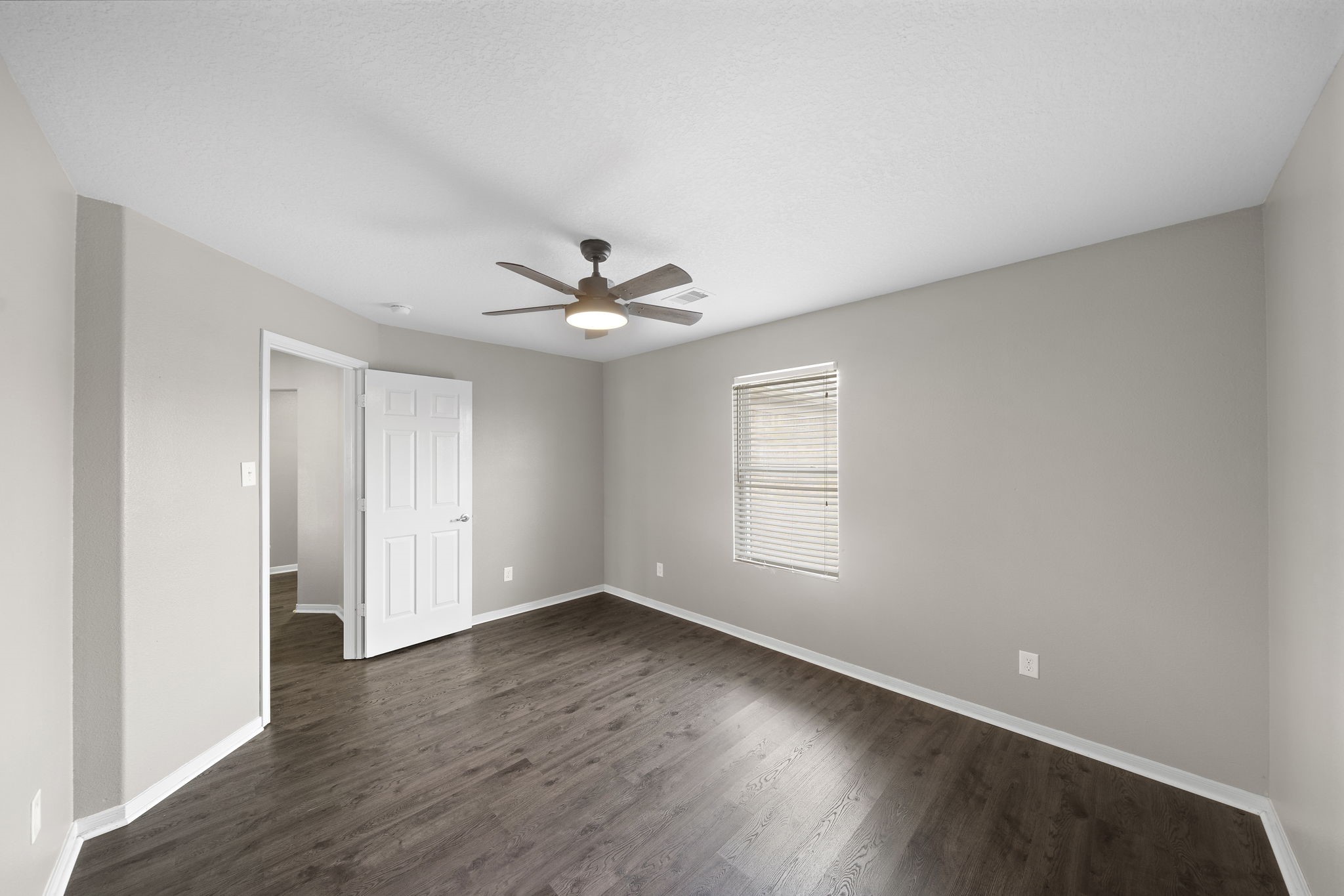 14422 Leafy Tree Drive Houston, TX 77090 - Photo 28 of 40 a view of empty room with wooden floor and fan