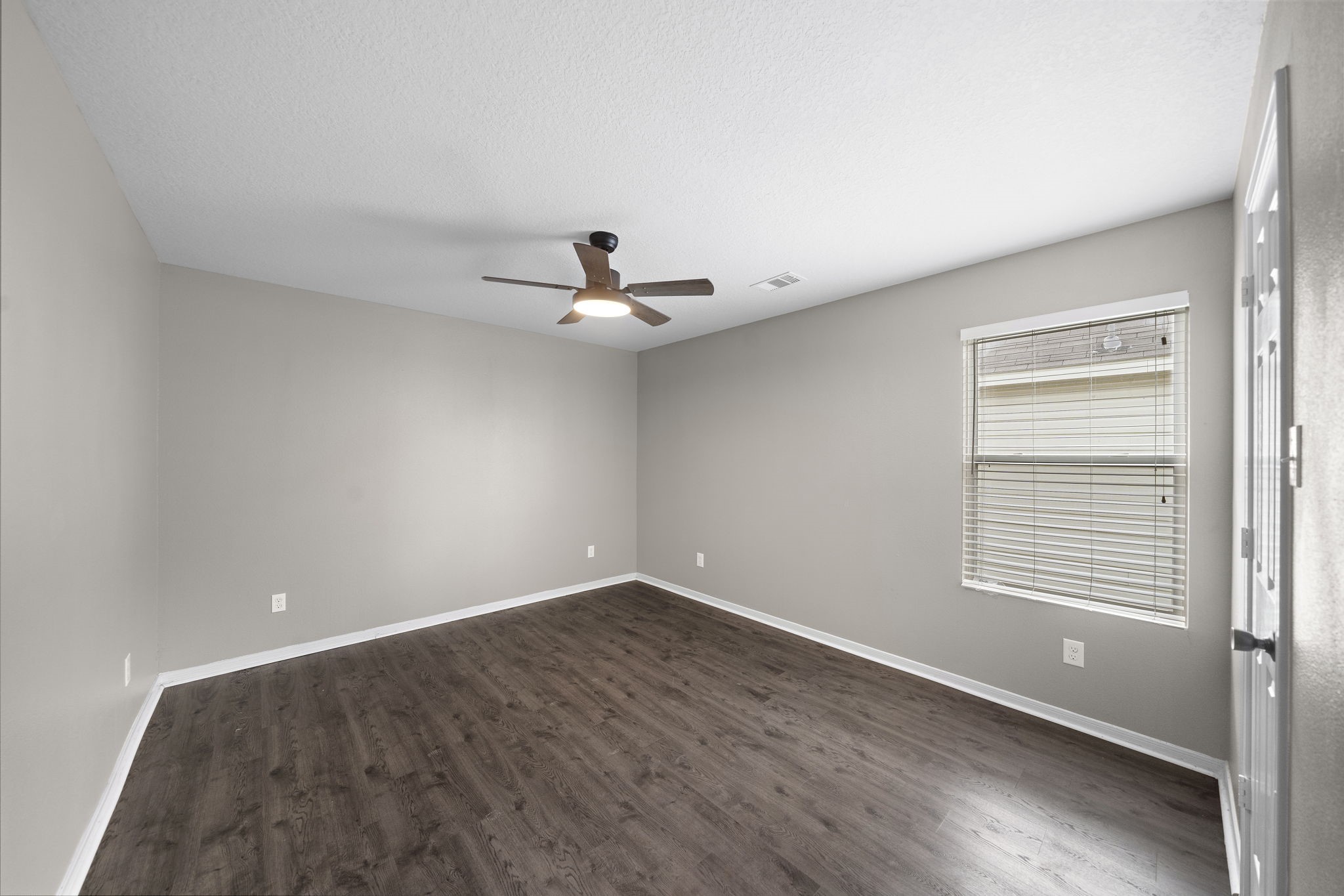 14422 Leafy Tree Drive Houston, TX 77090 - Photo 29 of 40 a view of a room with wooden floor and windows