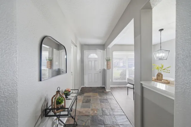 a view of a entryway door and dining room