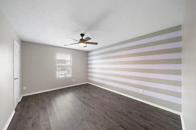 a view of room with window and hardwood floor