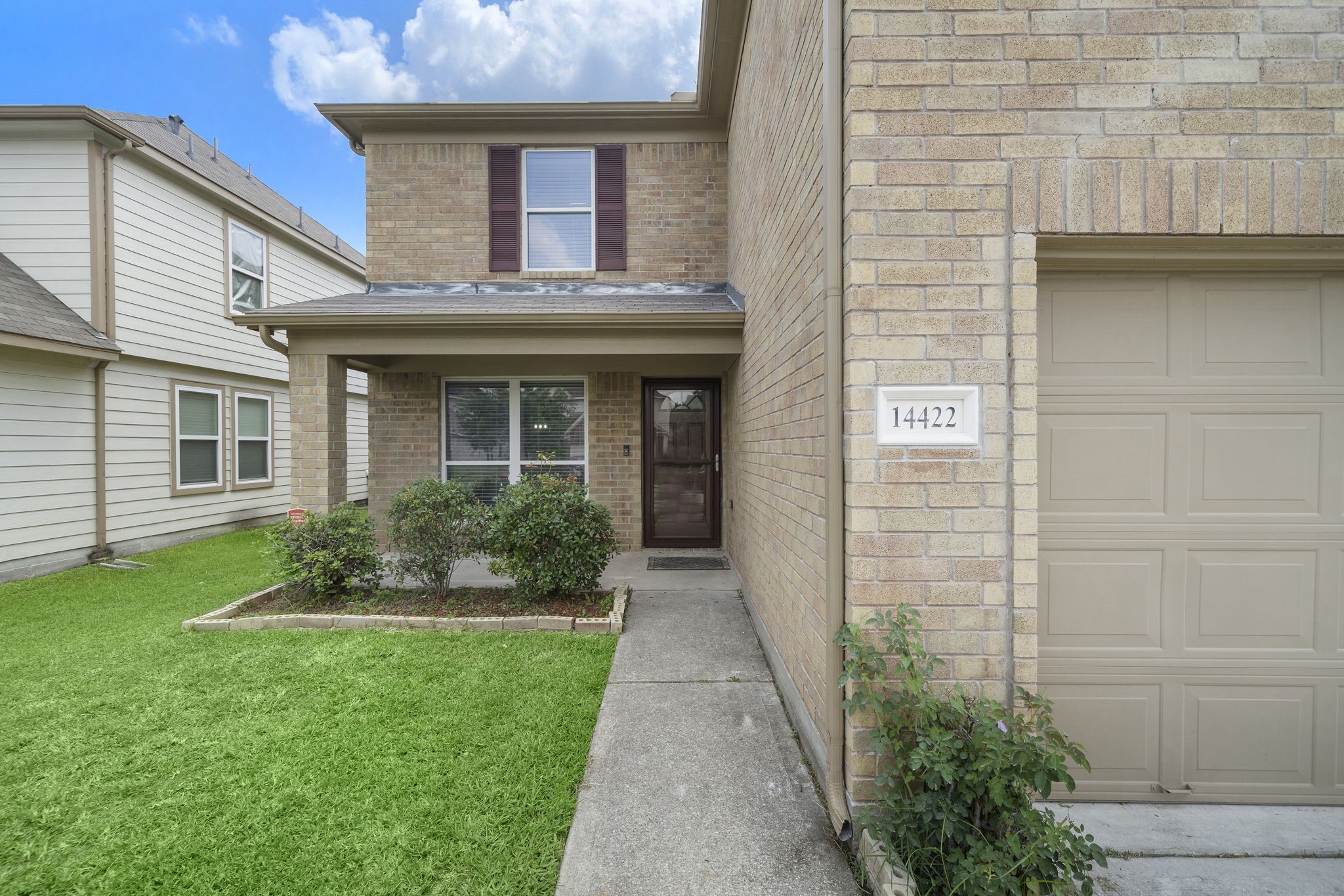 14422 Leafy Tree Drive Houston, TX 77090 - Photo 36 of 40 a view of a house with brick walls and a yard with plants